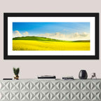 Rapeseed Field and Rolling Hills Under Blue Sky Wall Art