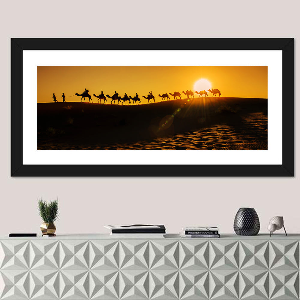 Camel Caravan Silhouette at Golden Sunset Wall Art in a room, panoramic