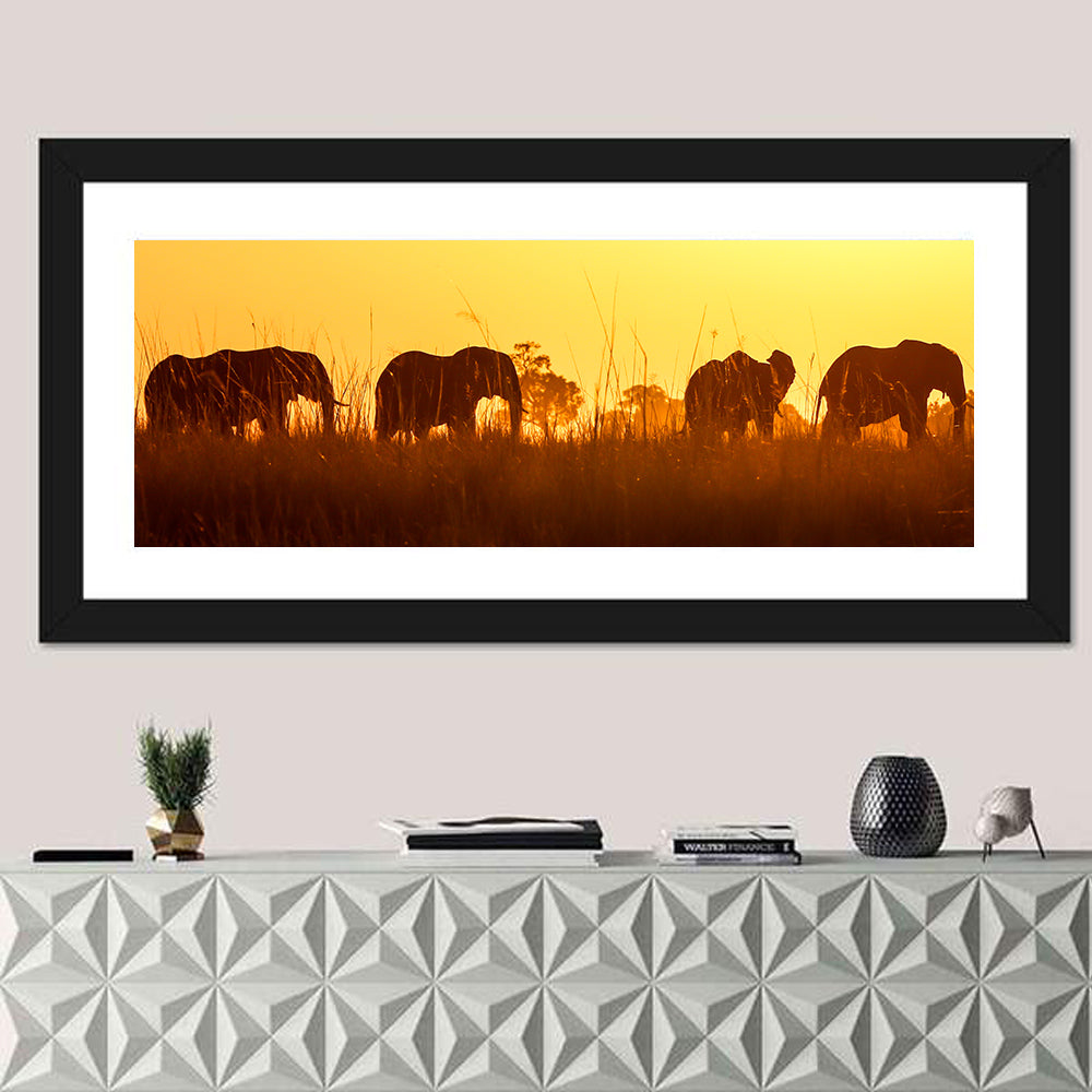 Golden Sunset Elephant Herd Wall Art in a room, panoramic
