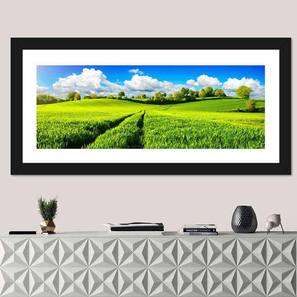 Tractor Tracks Through Green Rolling Hills Wall Art in a room, panoramic