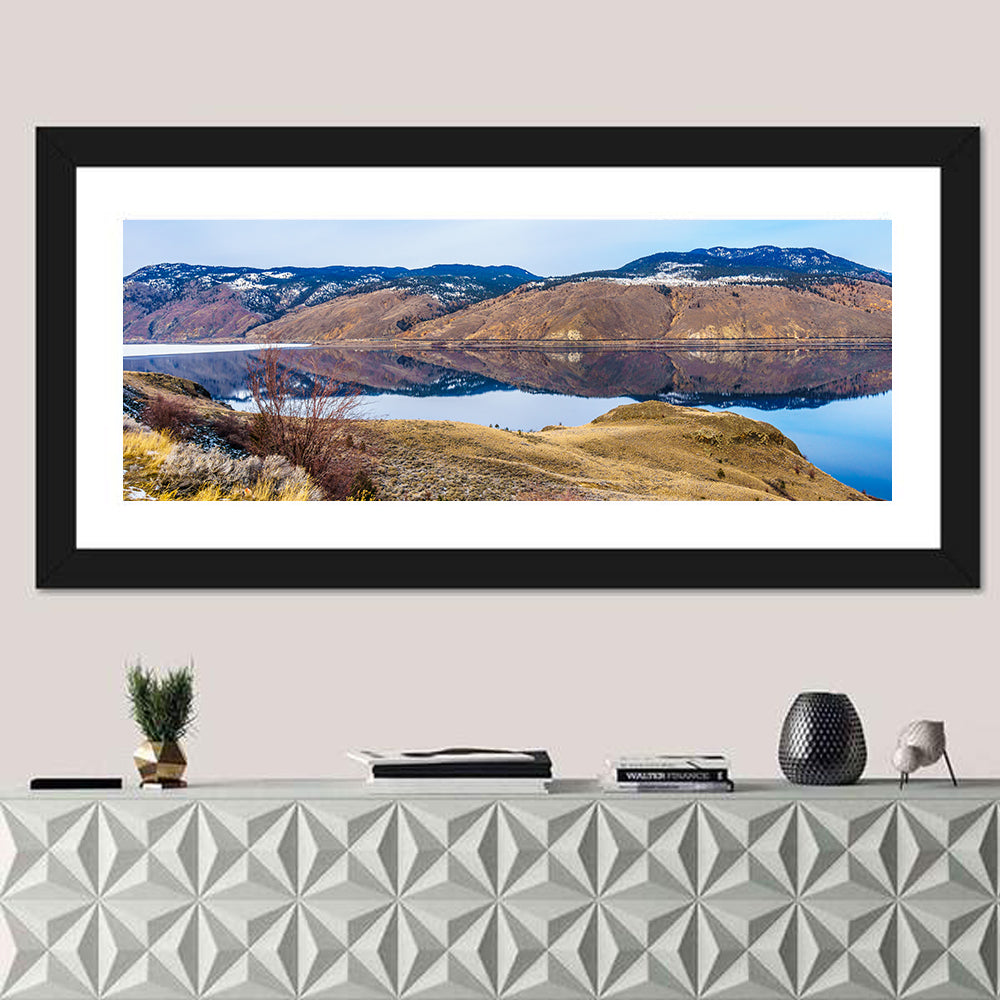 Kamloops Lake Mountain Reflection Wall Art in a room, panoramic