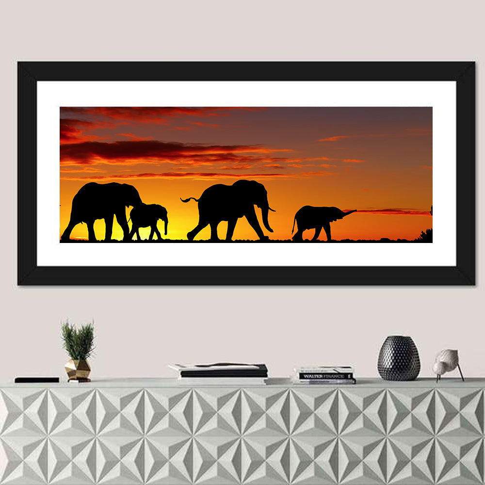 Elephant Herd at Sunset Wall Art in a room, panoramic