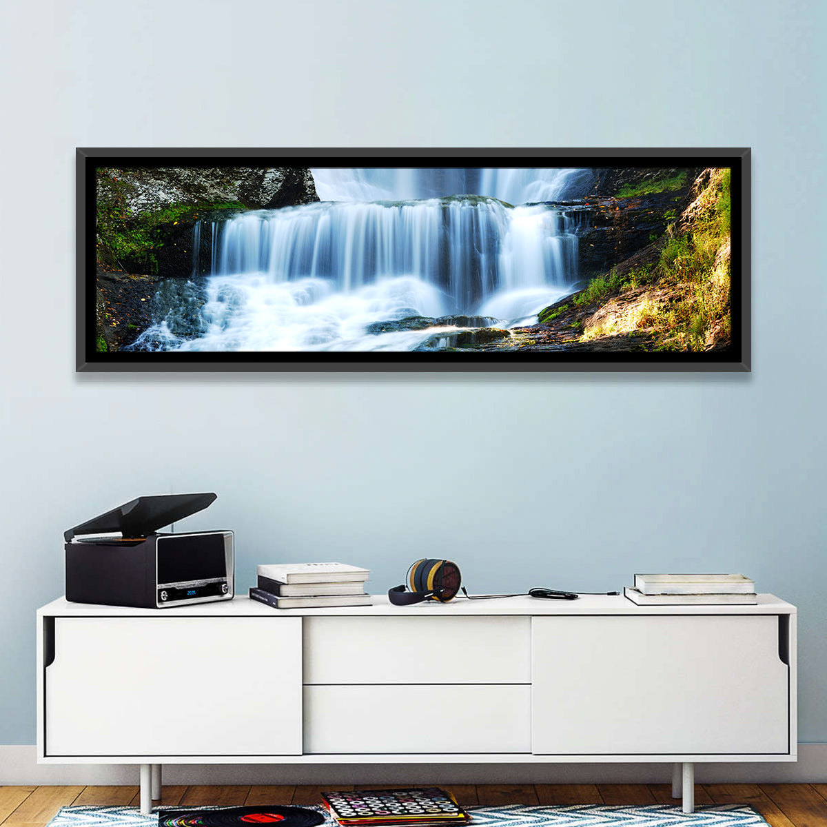 White Waterfall Over Mossy Rocks Wall Art in a room, panoramic