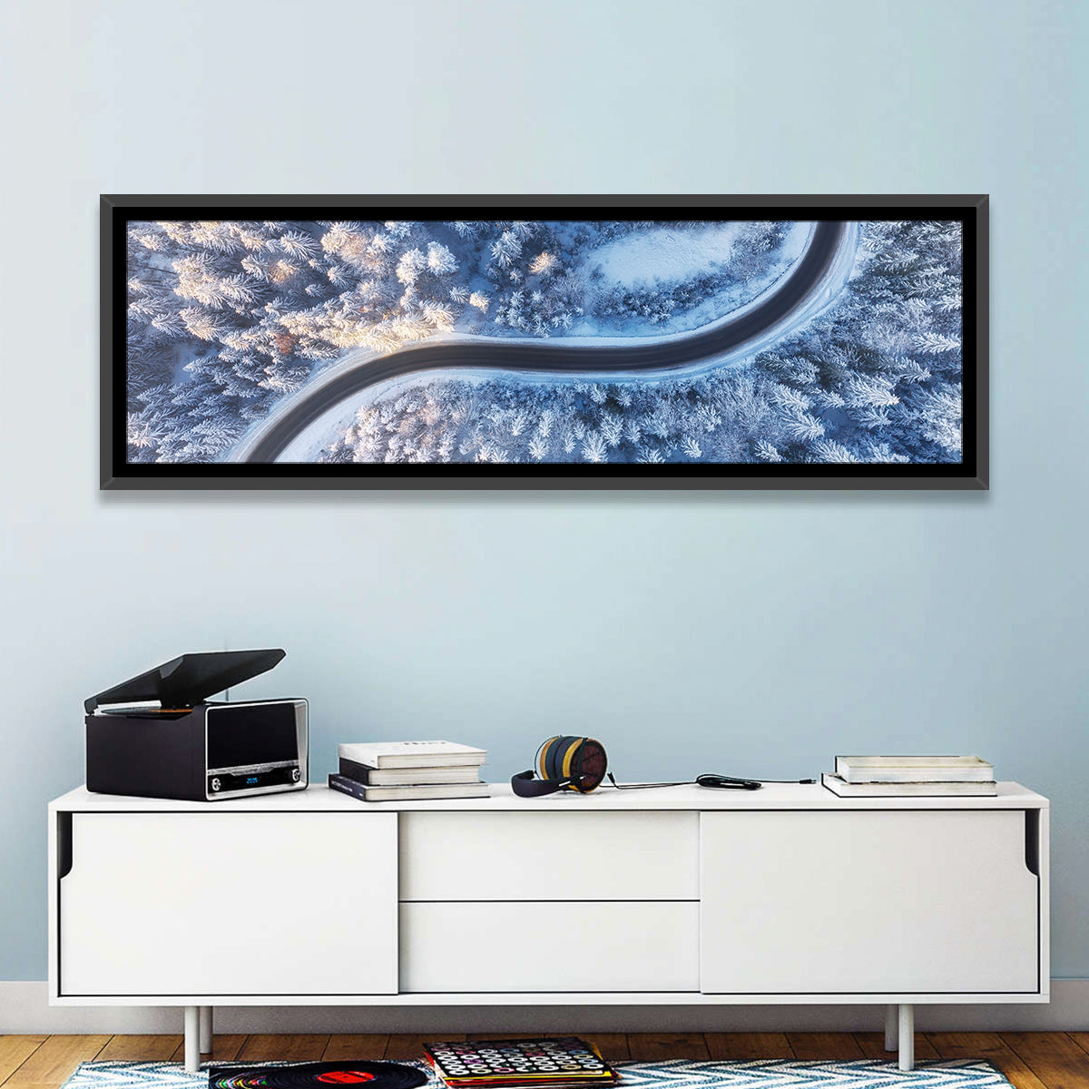 Winding Snow-covered Forest Road Wall Art in a room, panoramic