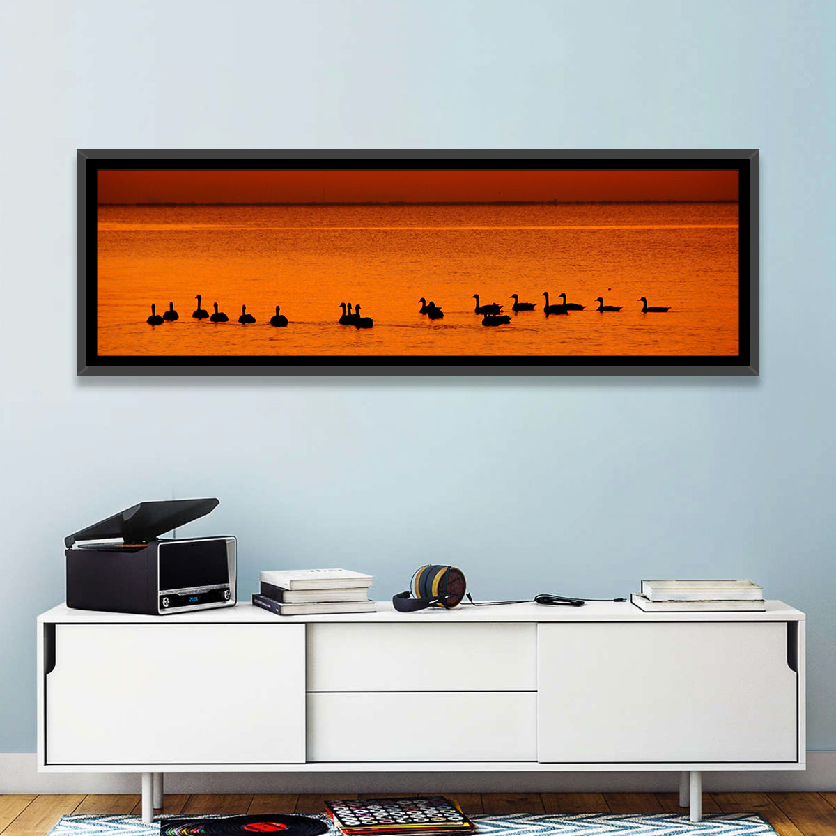 Geese Silhouettes at Orange Sunset Wall Art in a room, panoramic