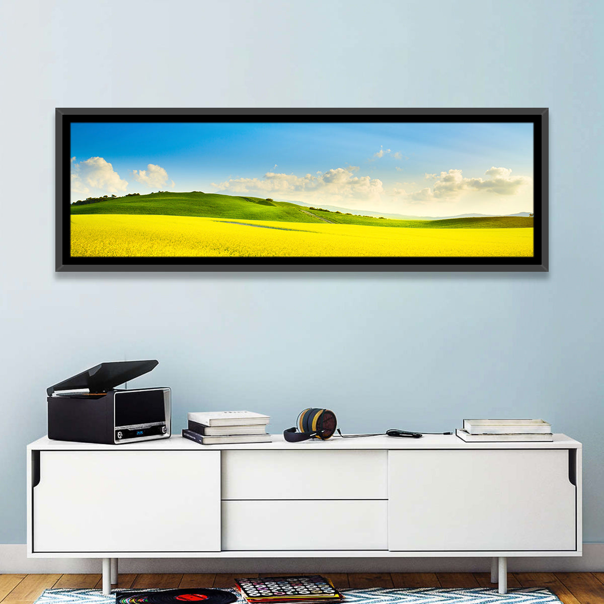 Rapeseed Field and Rolling Hills Under Blue Sky Wall Art in a room, panoramic