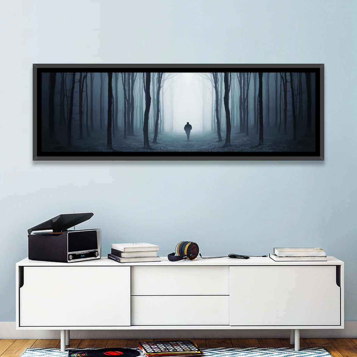 Lone Figure in Misty Forest Wall Art in a room, panoramic