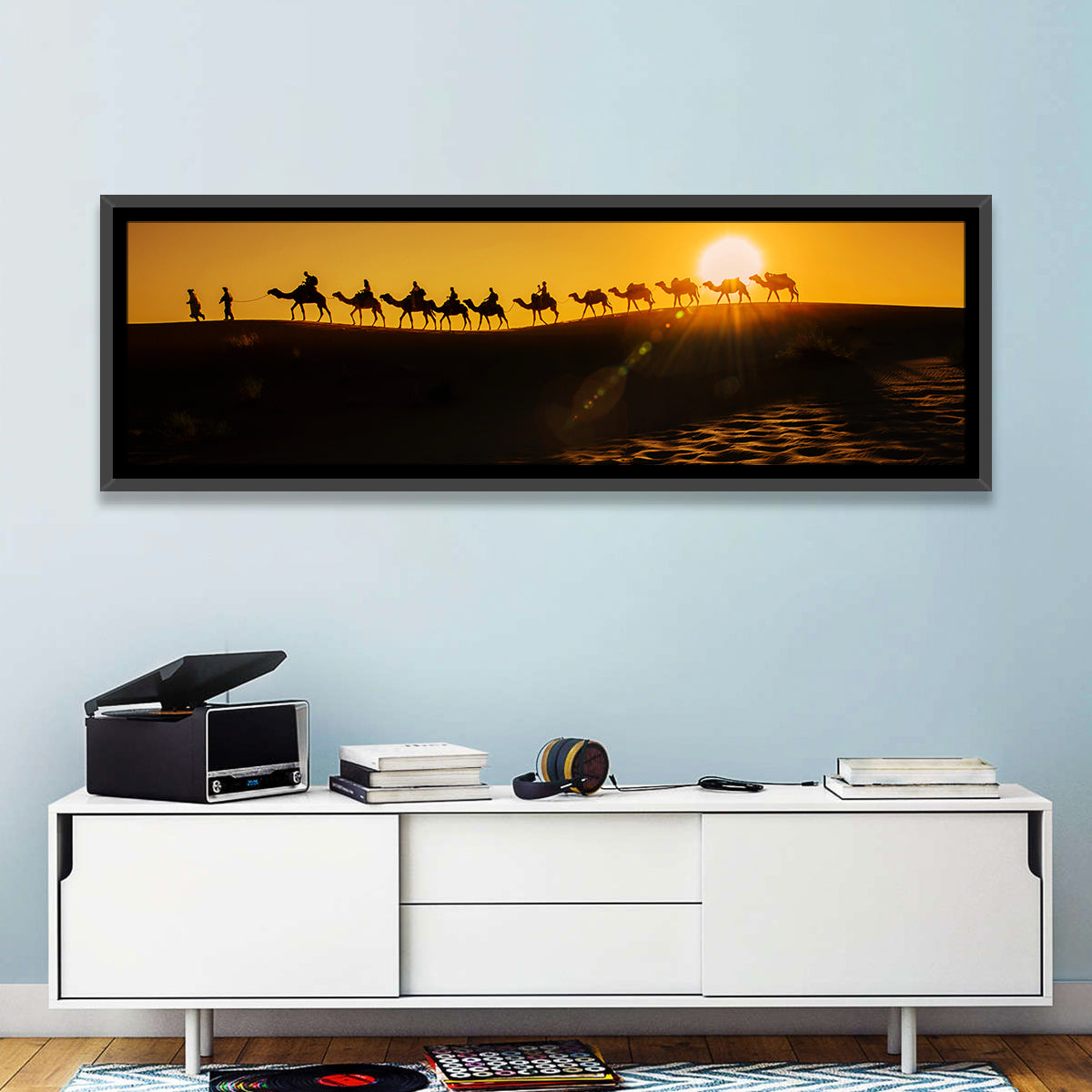 Camel Caravan Silhouette at Golden Sunset Wall Art in a room, panoramic