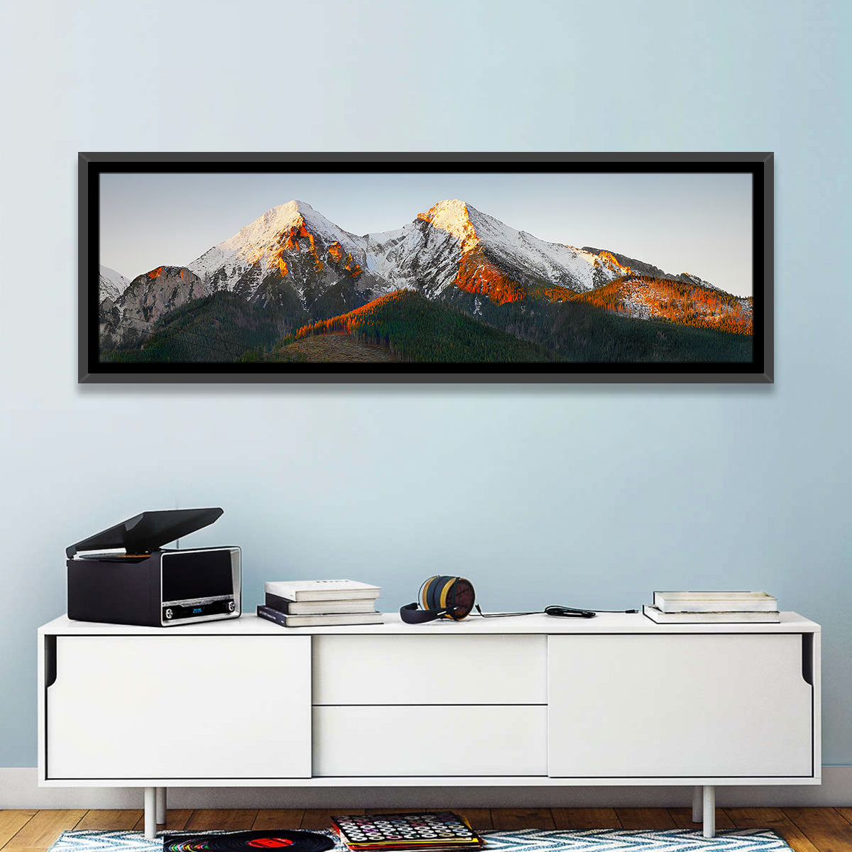 Sunlit Snow Capped Peaks Wall Art in a room, panoramic