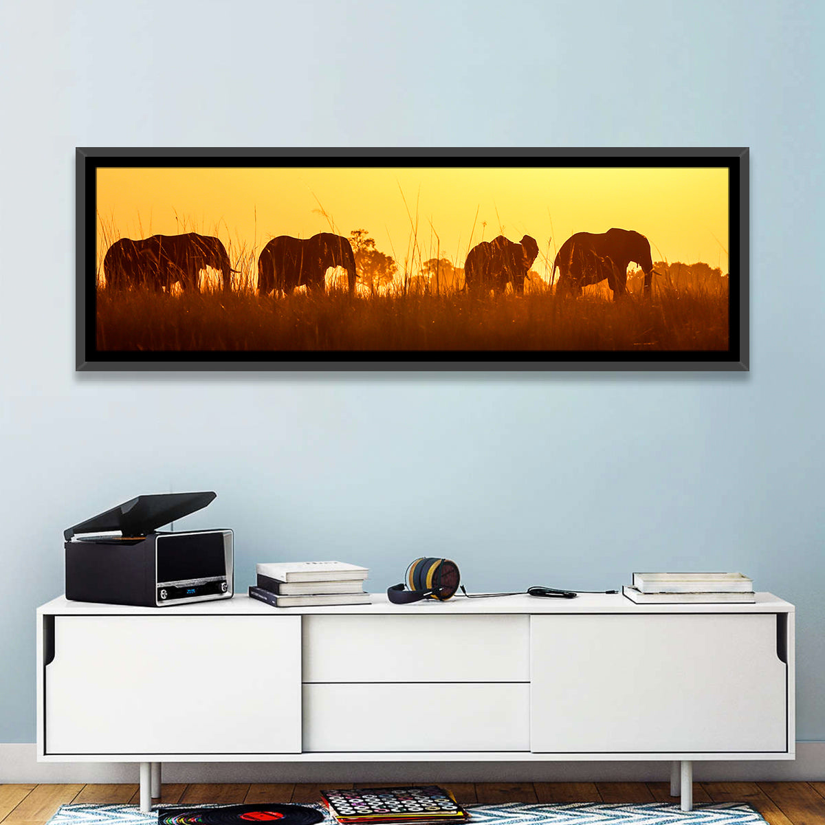 Golden Sunset Elephant Herd Wall Art in a room, panoramic