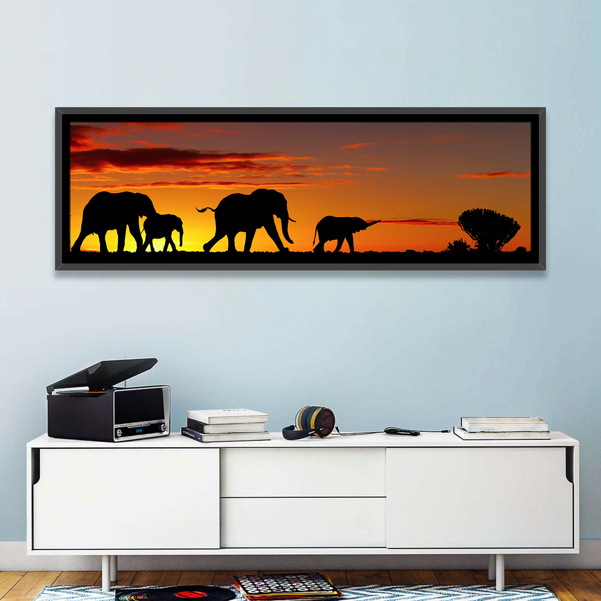 Elephant Herd at Sunset Wall Art in a room, panoramic