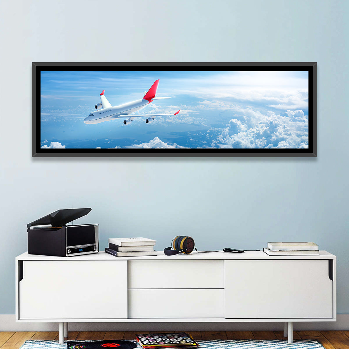 Airplane Over Blue Cloudscape Wall Art in a room, panoramic