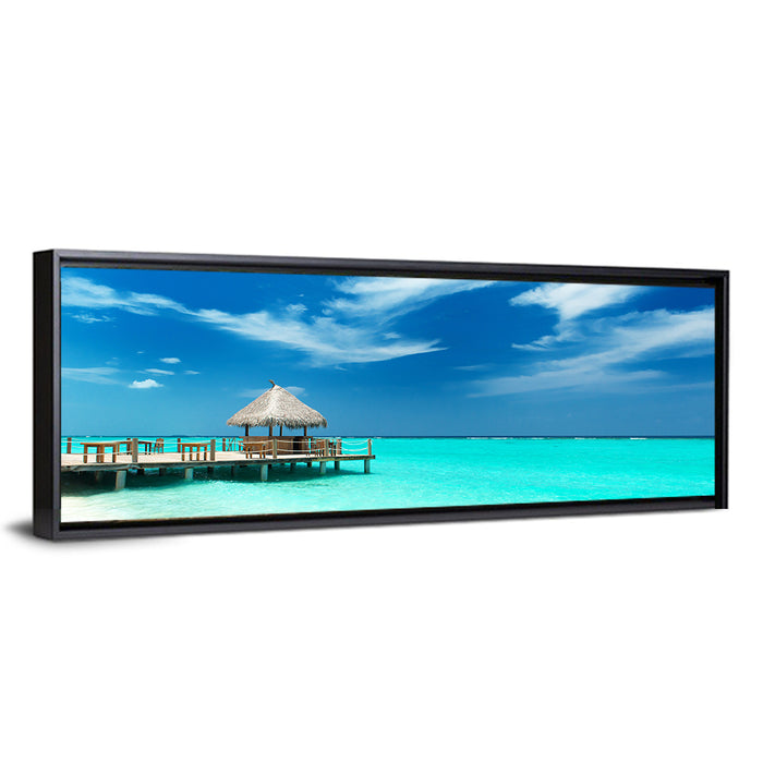 Thatched Beach Bar Pier Wall Art as a framed canvas