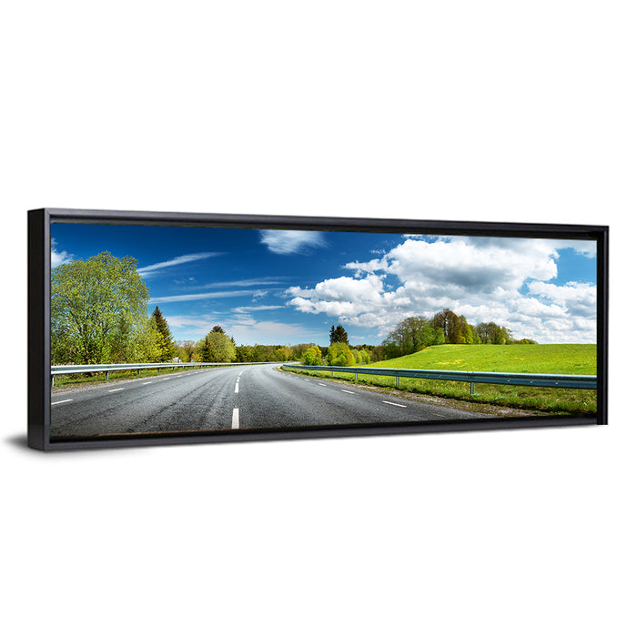 Sunlit Asphalt Road Wall Art as a framed canvas