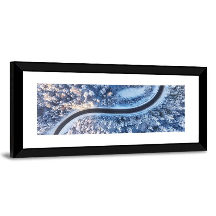 Winding Snow-covered Forest Road Wall Art as a framed print