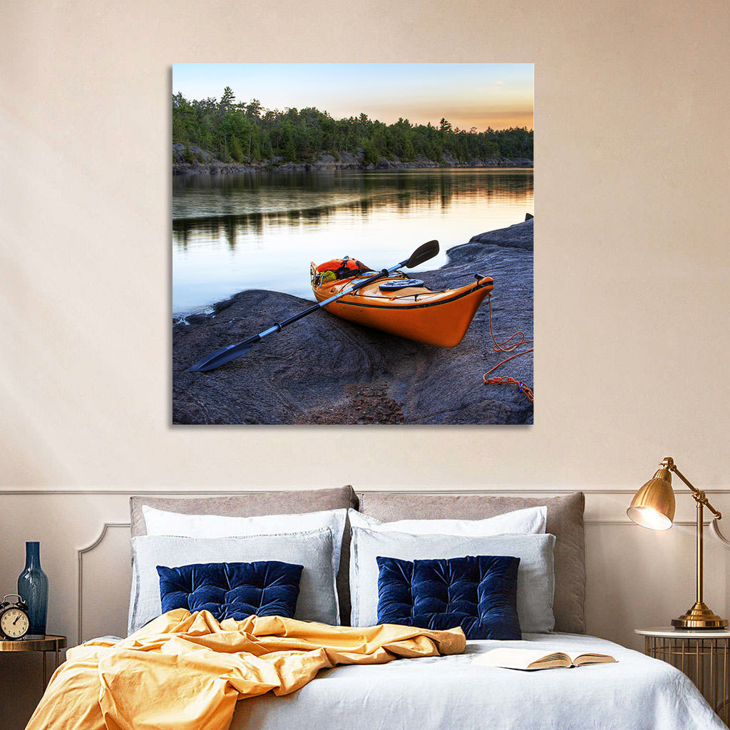 Orange Kayak on Rocky Shore Wall Art
