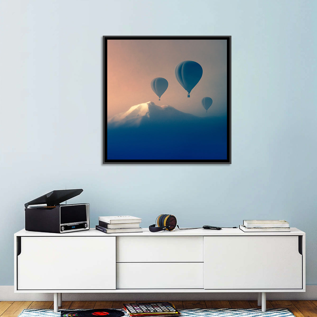 Three Hot Air Balloons Over Misty Peak Wall Art in a room, square