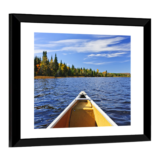 Yellow Canoe Bow on Blue Lake Wall Art as a framed print
