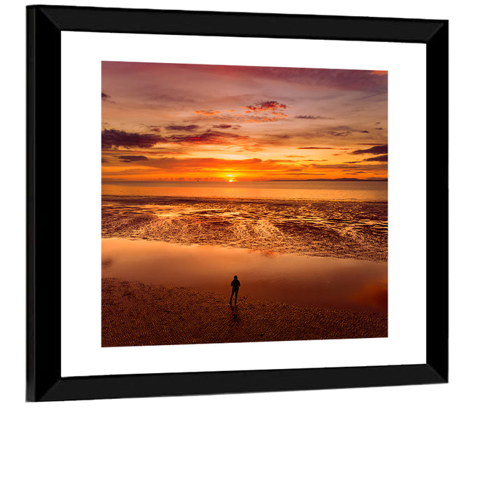 Solitary Figure on Sunset Shore Wall Art as a framed print