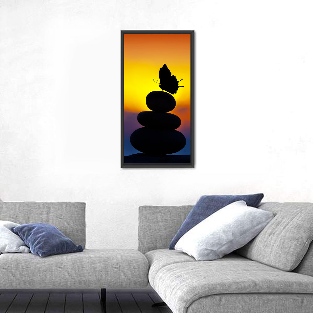 Stacked Spa Stones with Butterfly Wall Art in a room, portrait