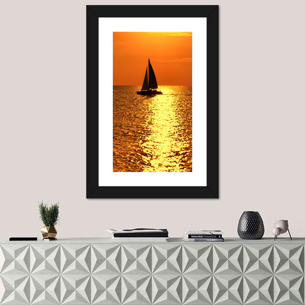 Sailboat Silhouette at Golden Sunset Wall Art in a room, portrait
